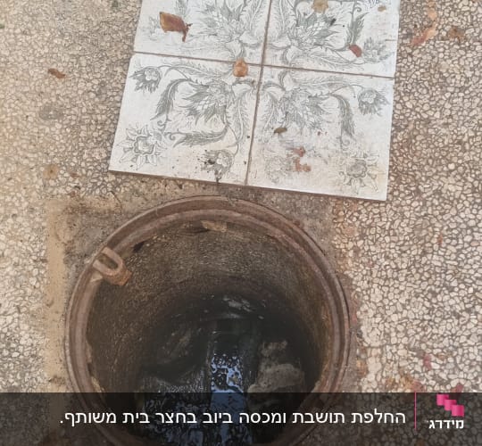 פתח ביוב פתוח עם מים בתוכו